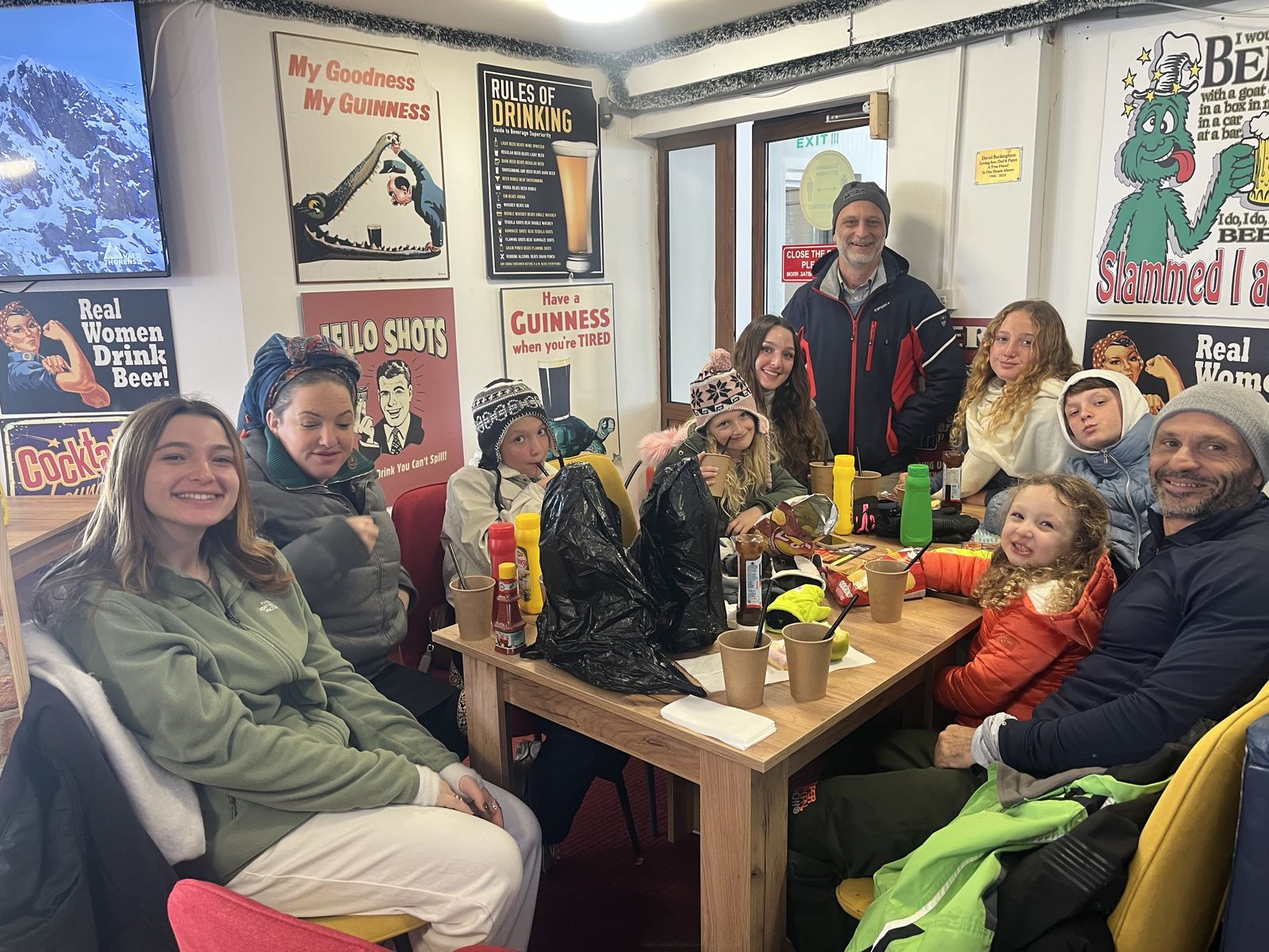 Everyone crowded around the pub table